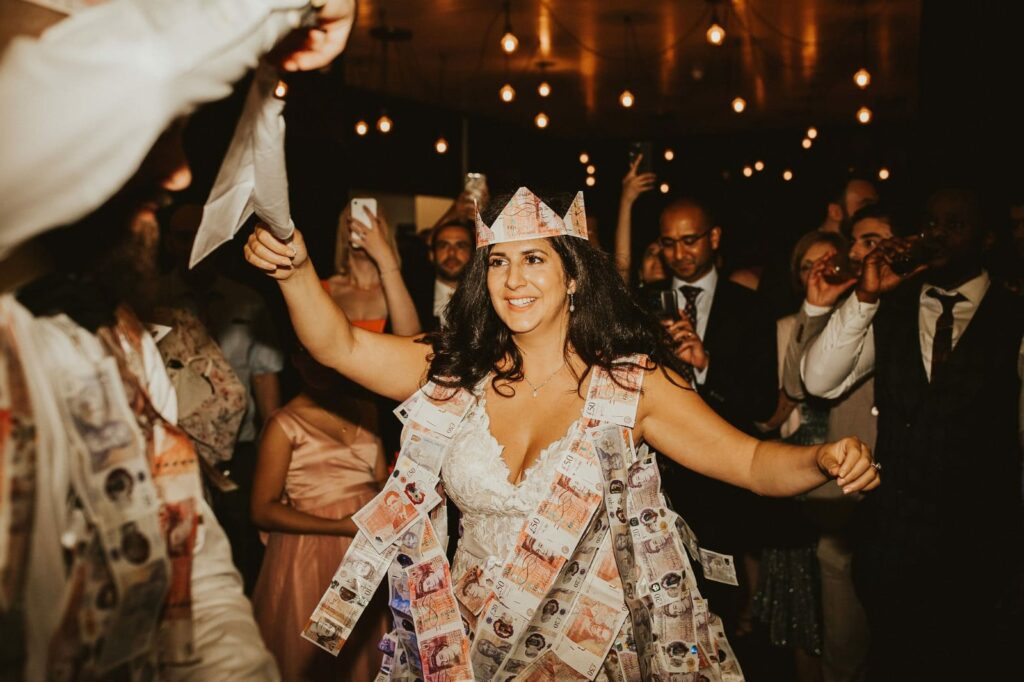 Guests joining the traditional Greek Money dance at the wedding reception