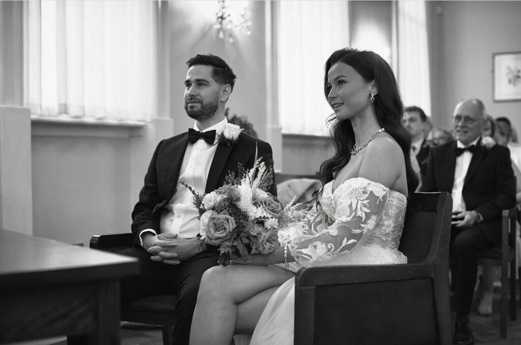 Wedding dress split alteration showing bride sitting during ceremony with elegant front split transformation