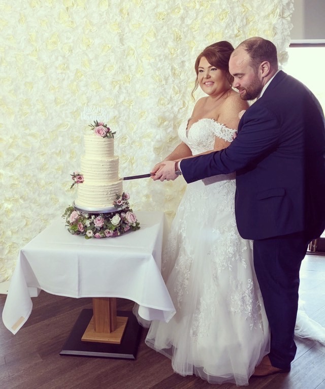 WED2B bridal alterations family referral wedding dress with corset support and bustle cake cutting