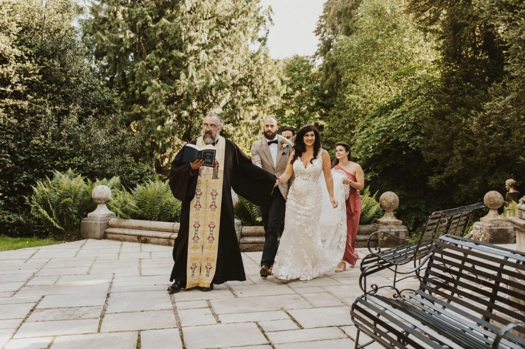 Allure Bridal alterations – bride getting walking to ceremony in her perfectly fitted Allure Bridal wedding dress