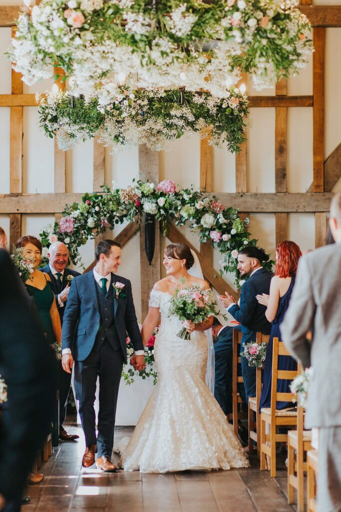 Bride wearing altered Anny Lin wedding dress during Surrey wedding ceremony with groom