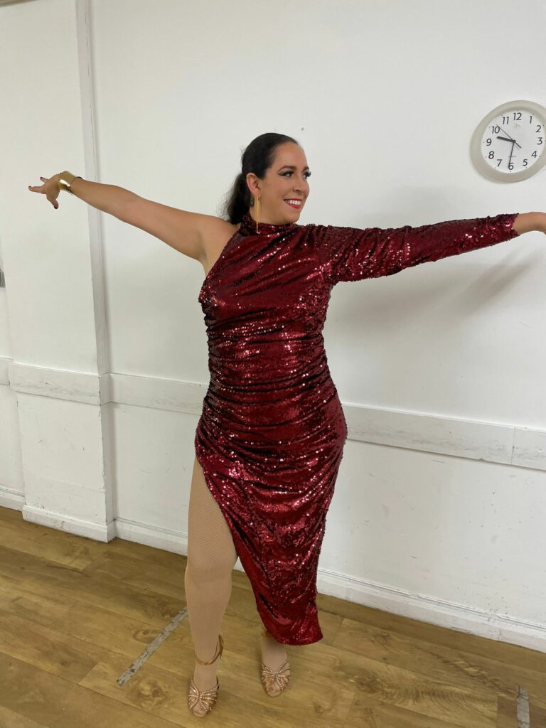 Red sequinned dance costume after specialist alterations including split repositioning, silhouette reshaping and hem adjustment.