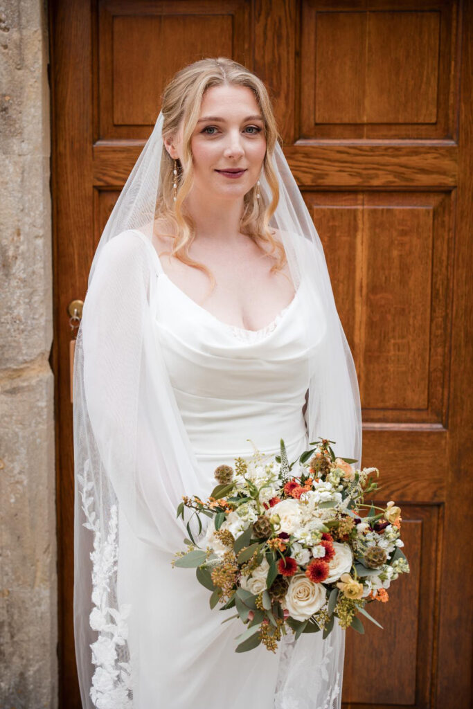 Bride wearing a Veni wedding dress after couture bridal alterations in Dorking with bespoke elements.