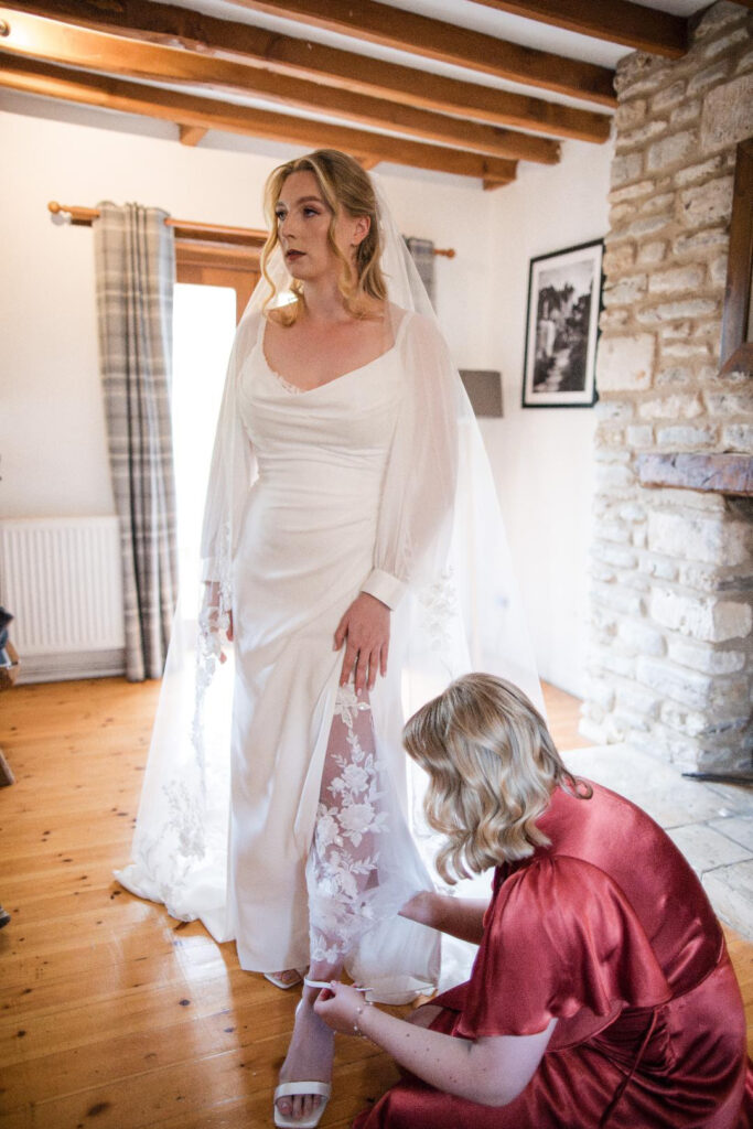 Bride wearing a Veni wedding dress after couture bridal alterations in Dorking with bespoke balloon sleeves and straps remade.