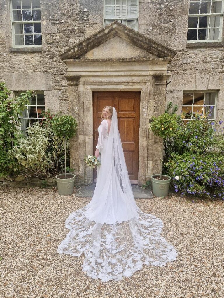 Bride wearing a Veni wedding dress after couture bridal alterations in Dorking with bespoke addition of balloon sleeves.