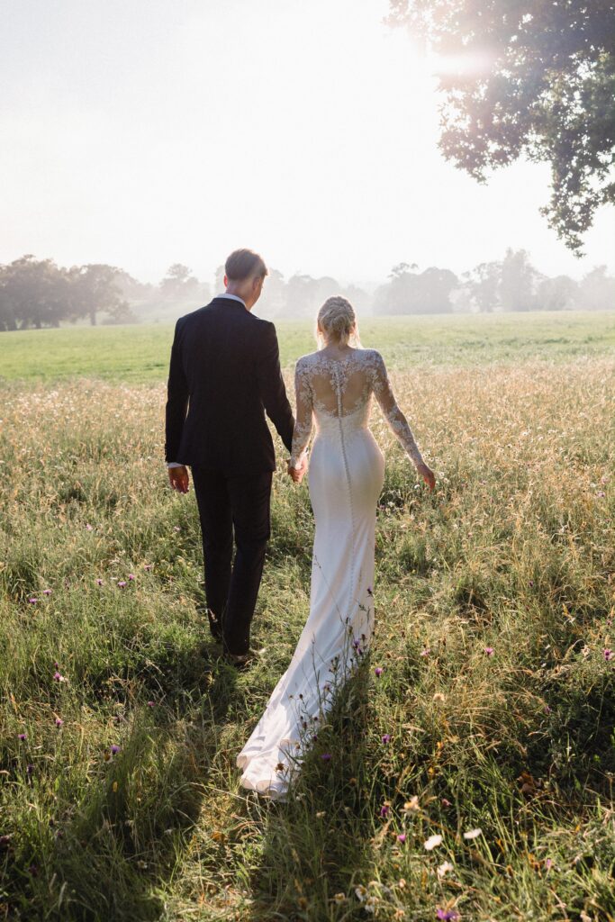 Elegant silhouette of a WED2B Fabien wedding dress after professional alterations bride and groom.