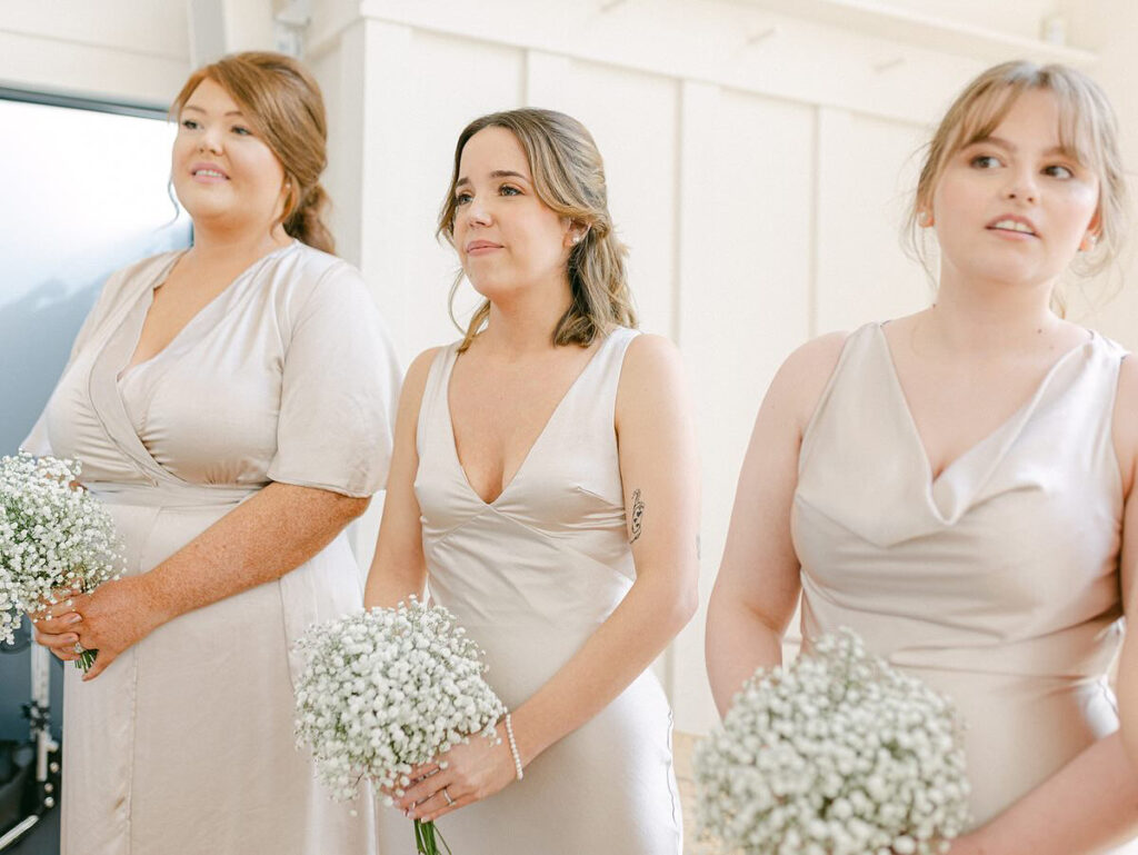 Sarah, a previous WED2B bridal alterations client, pictured as bridesmaid at the wedding.