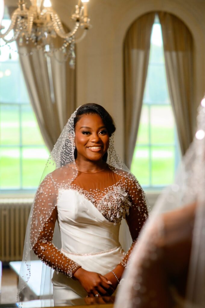 Bride admiring the perfect fit of her custom wedding dress following couture bridal alterations.