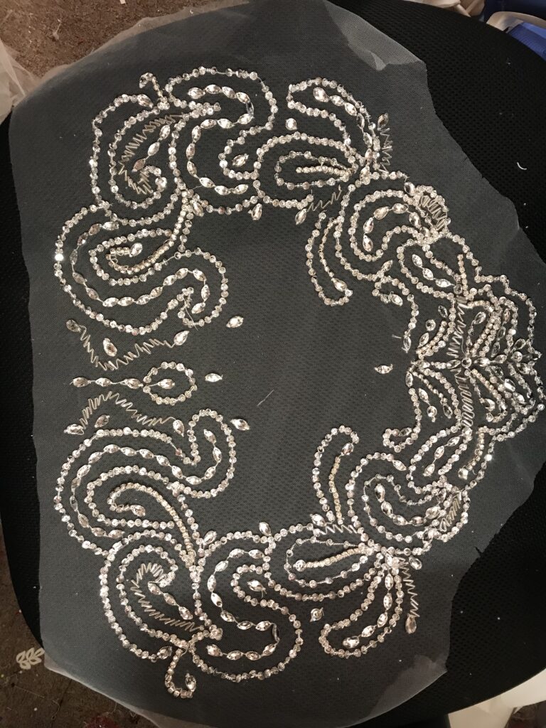 Couture crystal embroidery recreated by hand for bespoke illusion wedding dress sleeves.