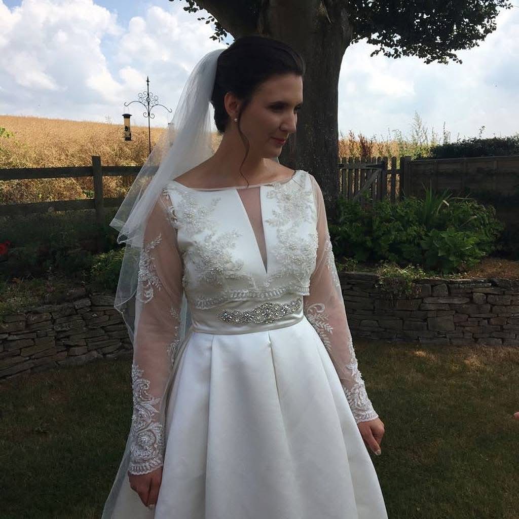 Bride wearing bespoke heavily beaded illusion bolero created from scratch for a Jesus Peiro wedding dress