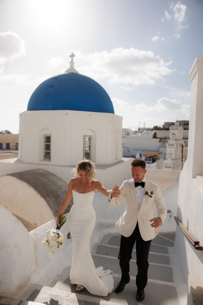Bride wearing a Duke by Khya Studios gown following expert Khya bridal alterations overlooking Santorini.