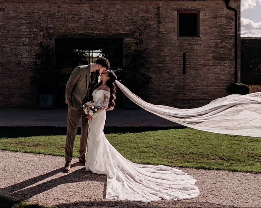 Beckenham bride wearing altered Martina Liana wedding dress with fitted lace sleeves during wedding flying cathedral veil details