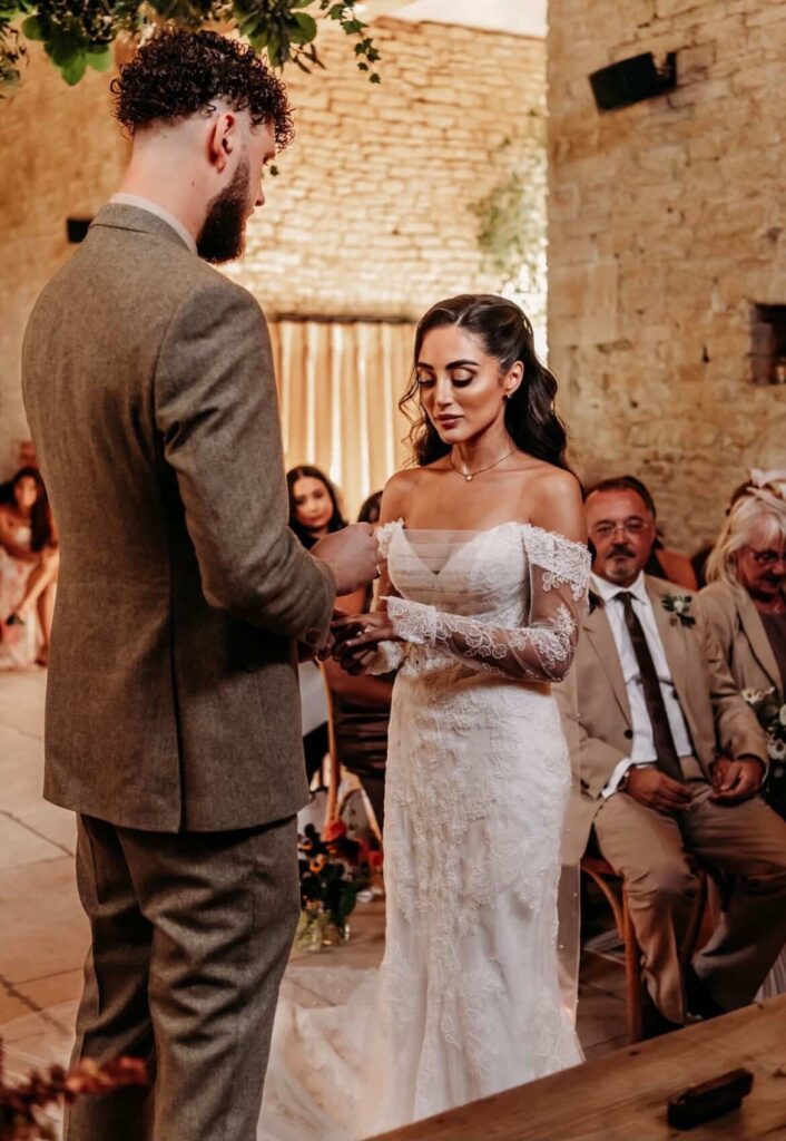 Beckenham bride wearing altered Martina Liana wedding dress with fitted lace sleeves during wedding vows