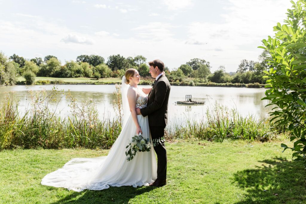 Redhill bride wearing altered Morilee wedding dress beside lakeside wedding venue