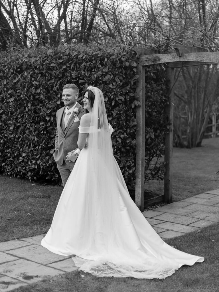 bridal portrait showcasing Stella York wedding dress alterations with cathedral veil and elegant silhouette.
