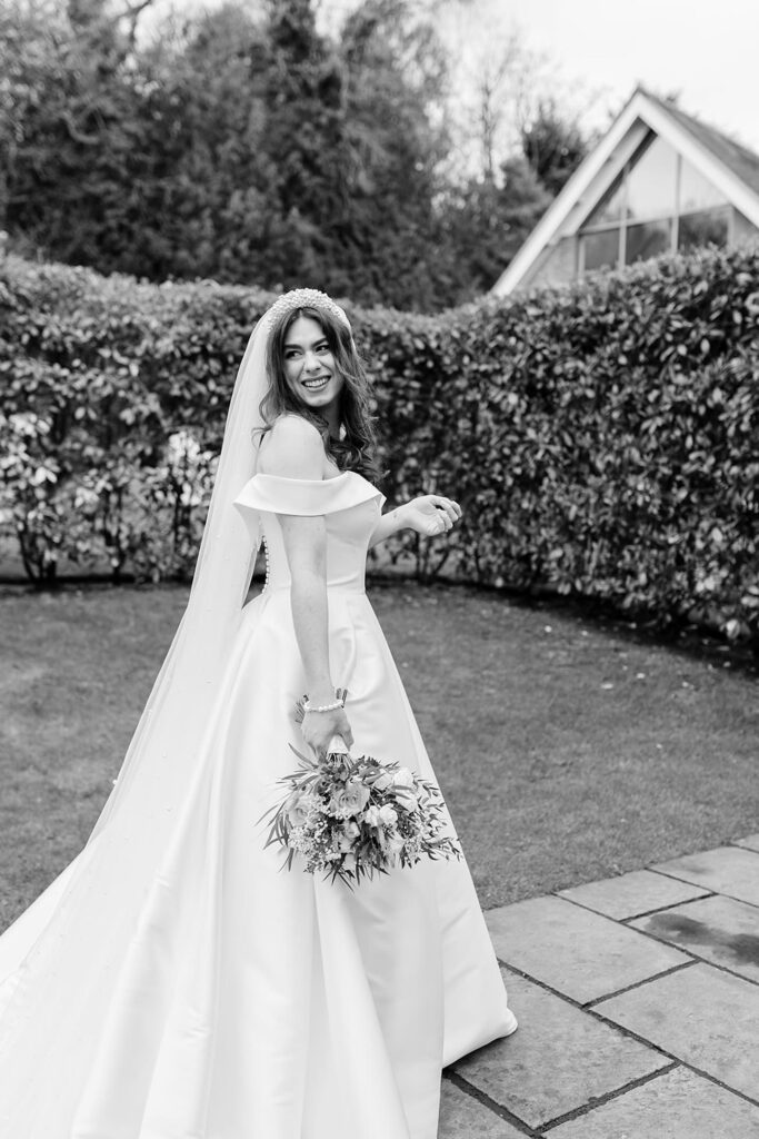 Black and white bridal portrait showcasing Stella York wedding dress alterations and elegant silhouette.