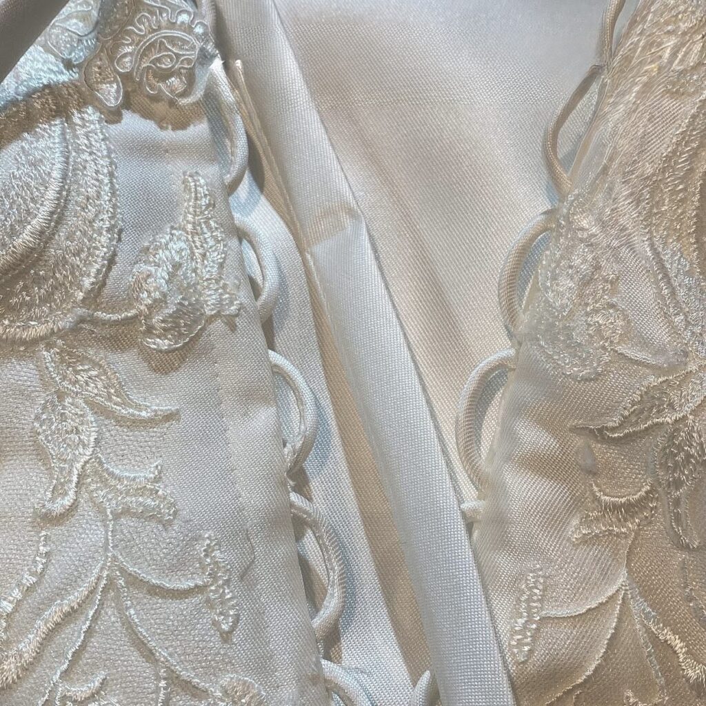Close-up of Stella York wedding dress bodice after bridal alterations with hidden bust support and bespoke modesty neckline back tie back conversion