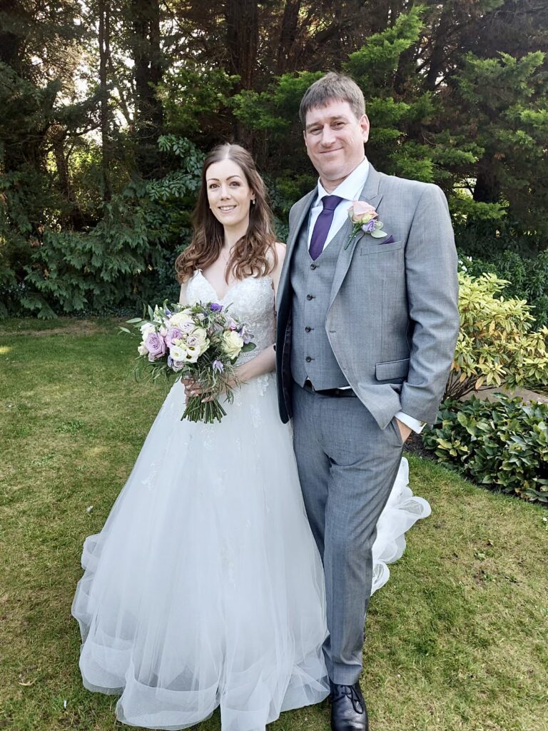 Bride wearing customised Stella York wedding dress with bespoke crystal straps and rhinestone belt