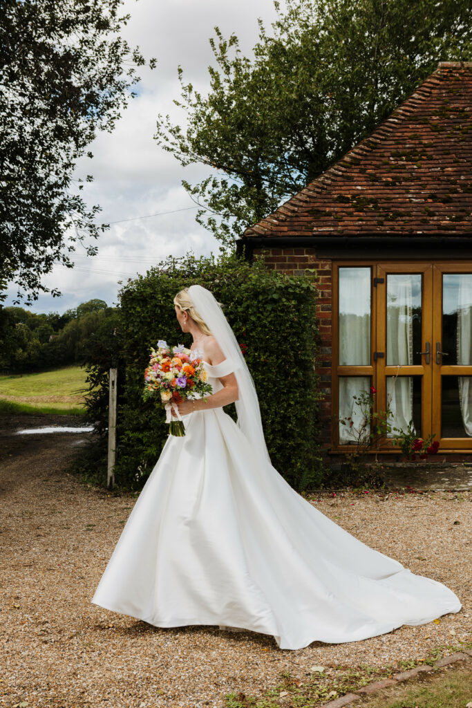Train side view of Stella York wedding dress following three-size reduction alterations