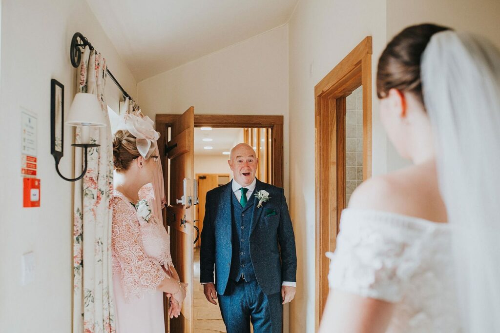 Bride wearing her altered Anny Lin wedding dress during a first look with her father