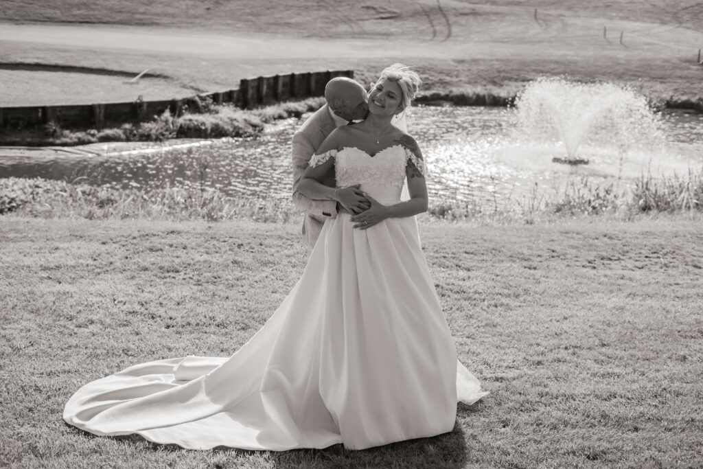 Anna Sorrano Bridal Alterations – romantic lakeside portrait showing the full train of a WED2B wedding dress