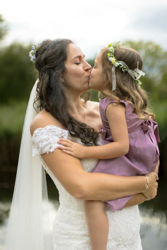 Wedding photography showing bridal alterations completed for a Morden bride kissing daughter