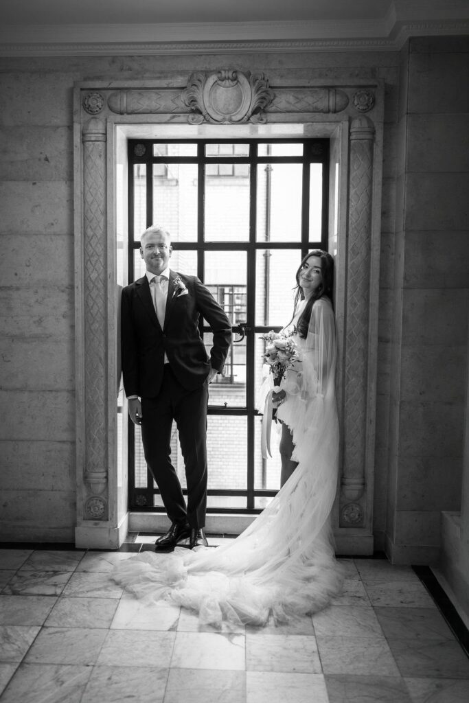 black & white picture of perfectly fitted dress on Marylebone registration office steps