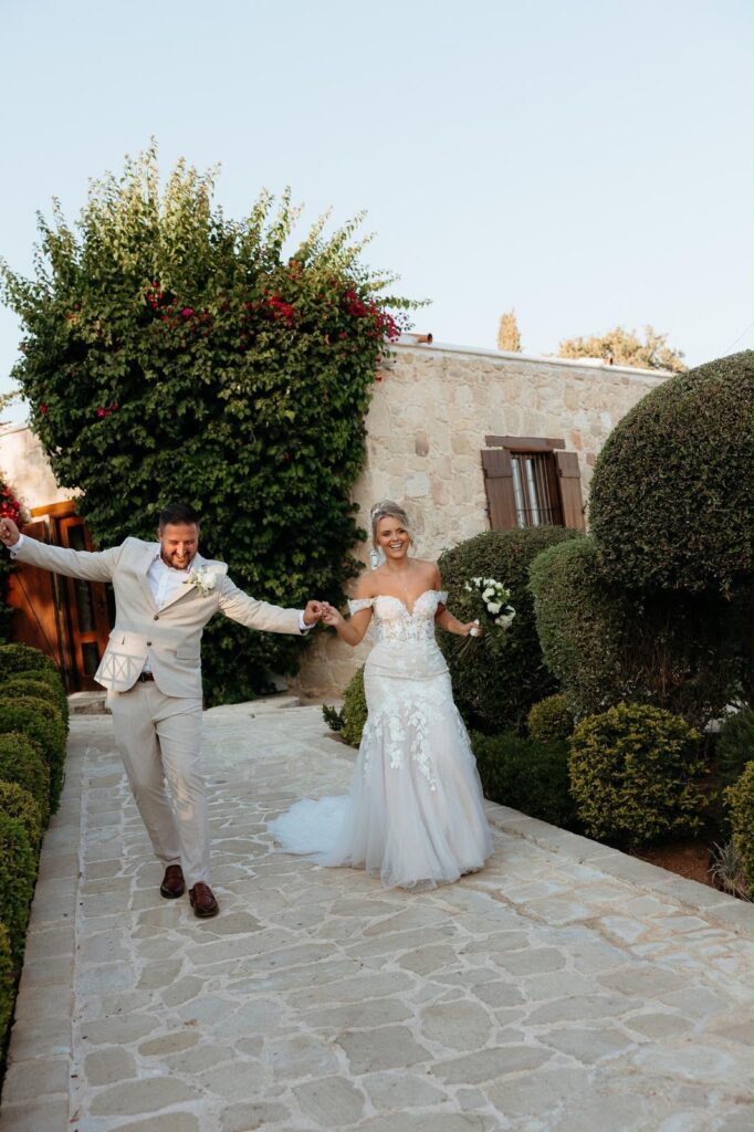 Bride walking in Mark Lesley sample wedding dress flowing train