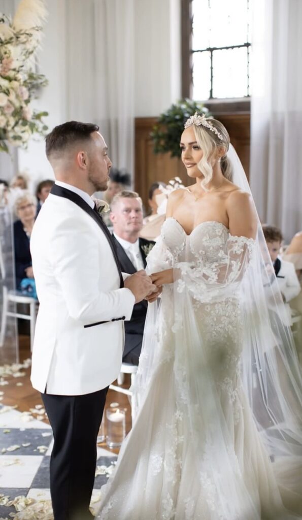 Expert Martina Liana wedding dress with flowing train and perfectly fitted bodice after couture alterations