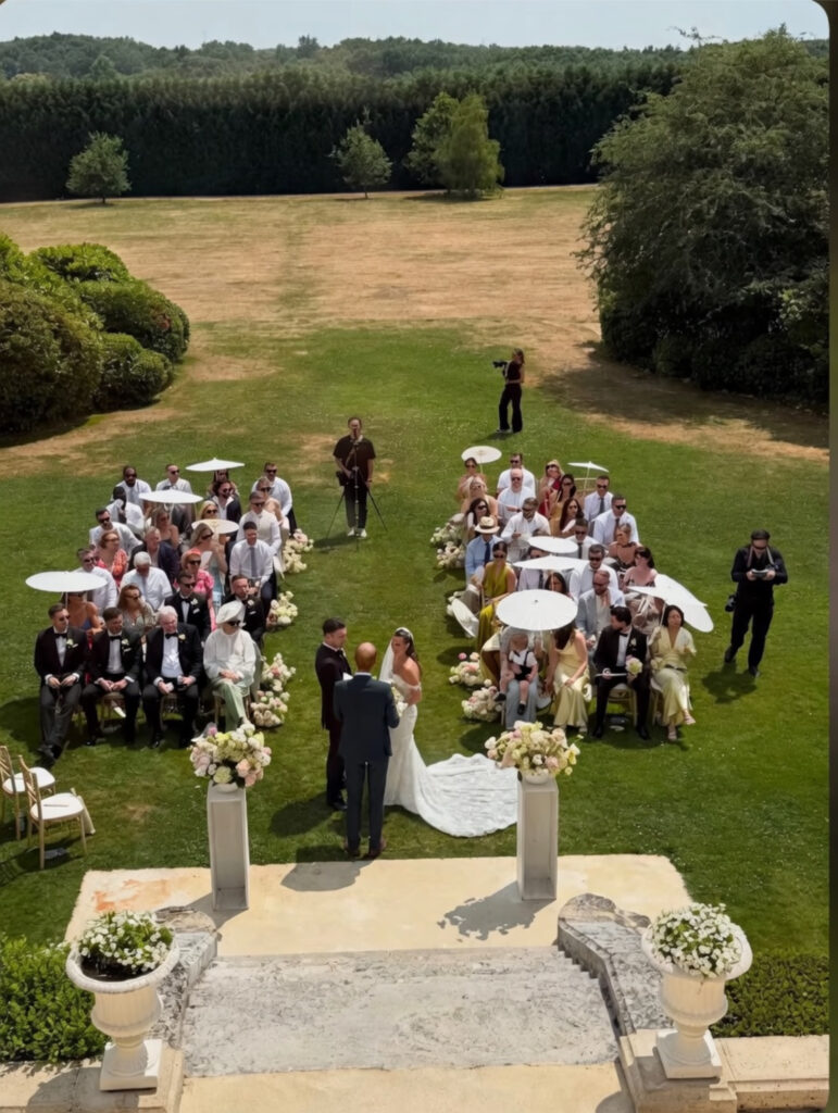 Bride wearing a Ricca Sposa Como wedding dress during an outdoor ceremony at Château Fengari in France after couture bridal alterations