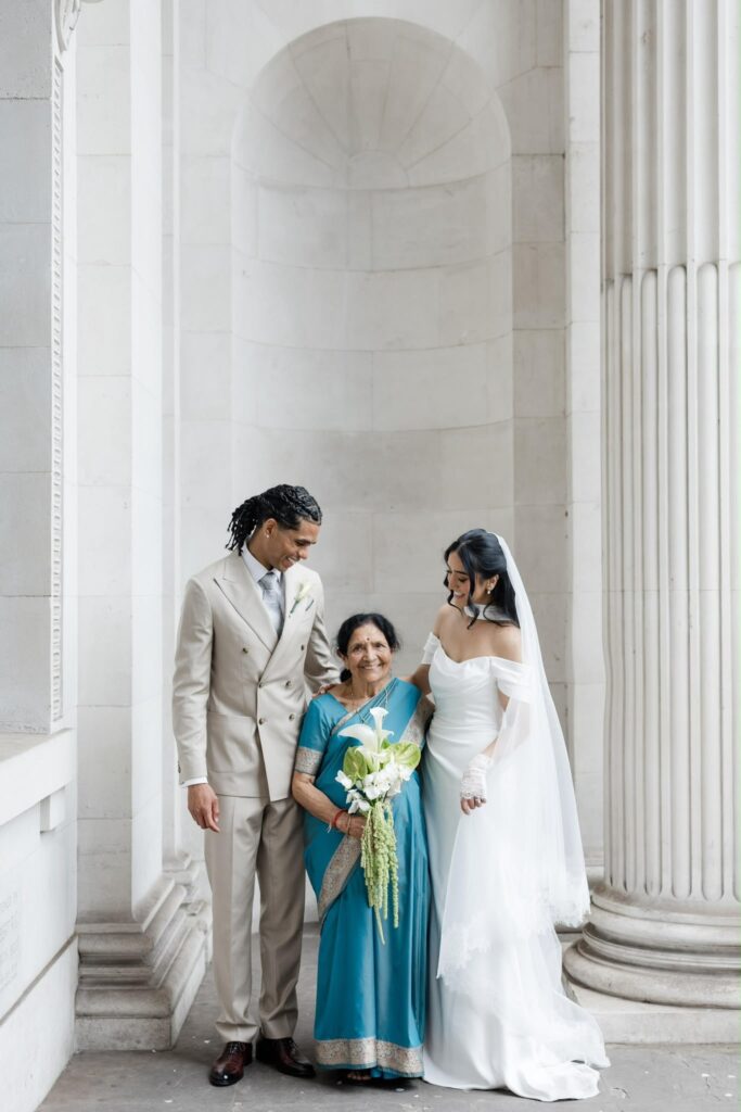 emotional picture with maternal grandmother with bride and groom