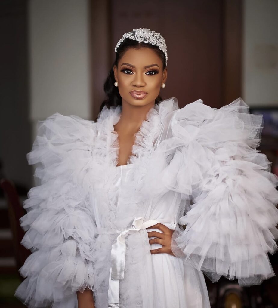 Lagos bride wearing a dramatic tulle bridal robe during her wedding morning preparations.