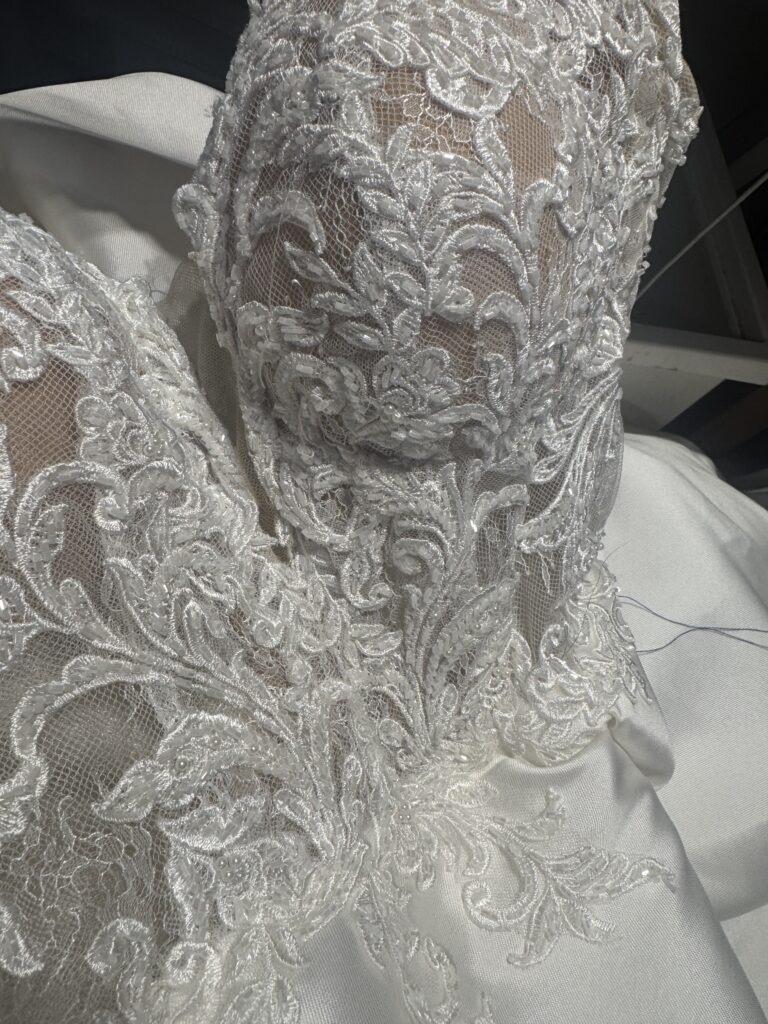 Beaded lace bodice of Essense of Australia wedding gown during bust contouring alterations