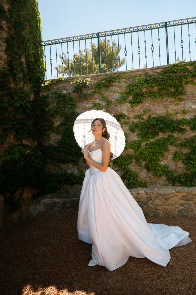 Final fitting of a KYHA Miles strapless corset wedding dress with tailored waist and shortened skirt.