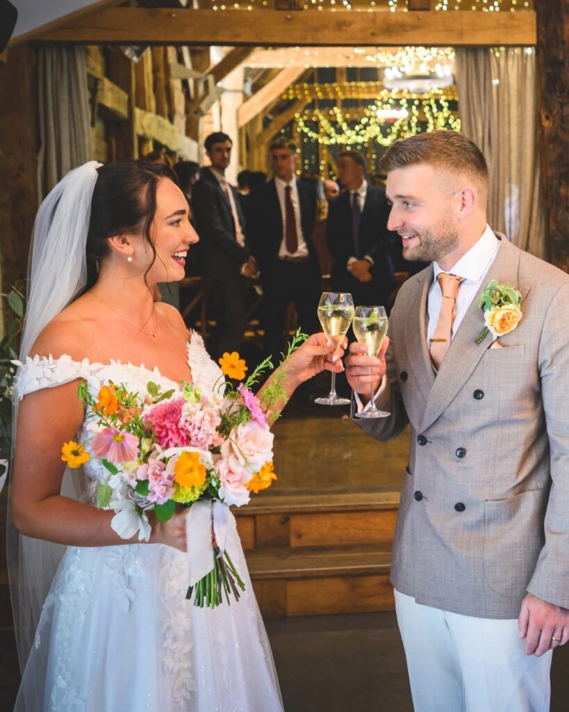 bride and groom happily making a toast.