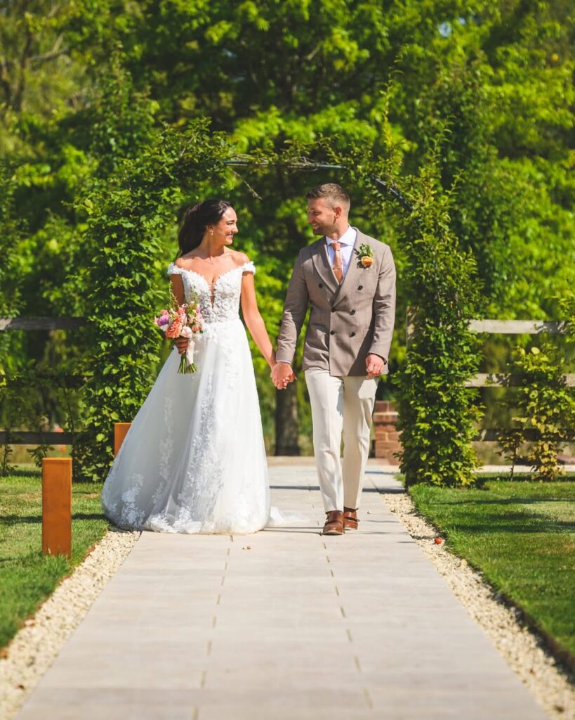 Bride wearing a beautifully fitted lace wedding dress after luxury bridal alterations done to perfection.