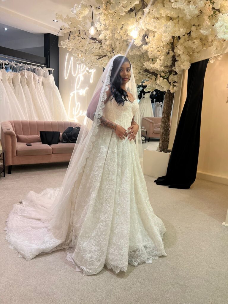 Bride wearing an Allure Abella Carrington wedding dress at Aurora Bride Boutique before alterations.