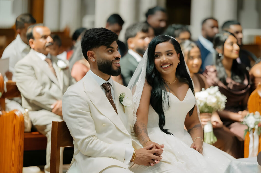 bride sitting comfortably in church during ceremony in her beautifully fitted dress.
