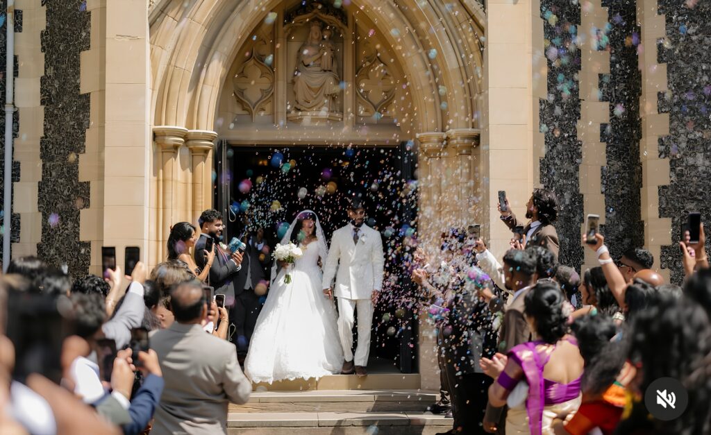 Bride and groom celebrating after the ceremony with an altered Allure wedding dress.