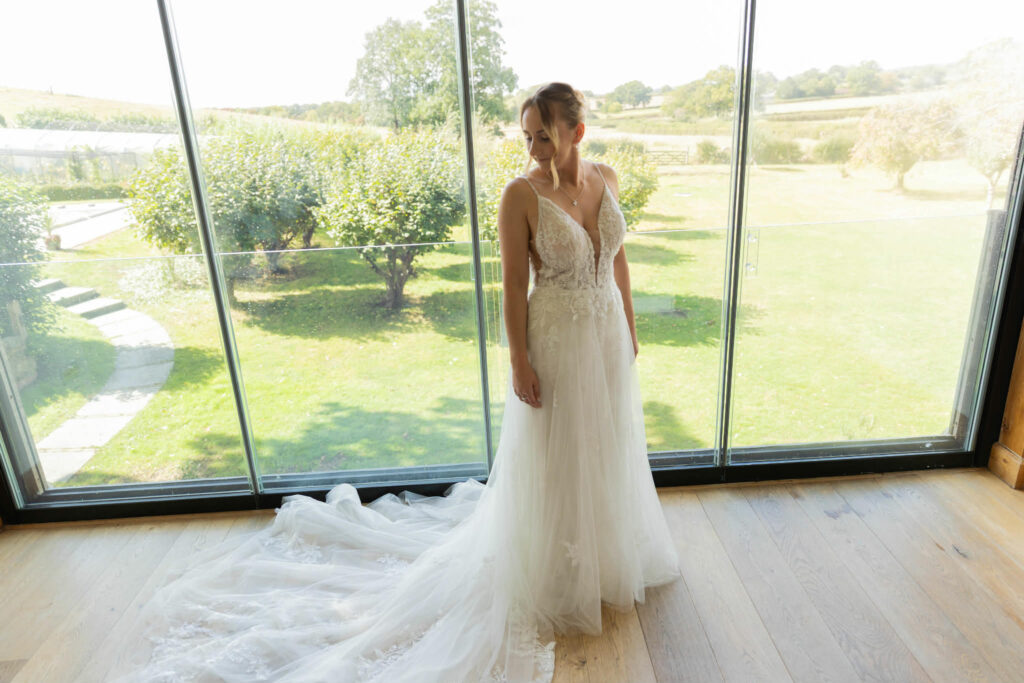 Kenley wedding dress alterations on an Essense of Australia bridal gown with couture reshaping and expert sample dress fitting major 4-5 size reduction.