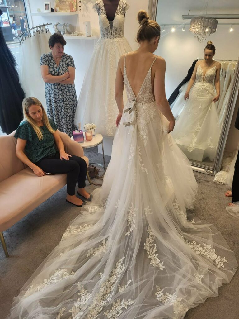 Before Kenley wedding dress alterations showing an Essense of Australia sample gown pinned for an eight-inch huge size reduction