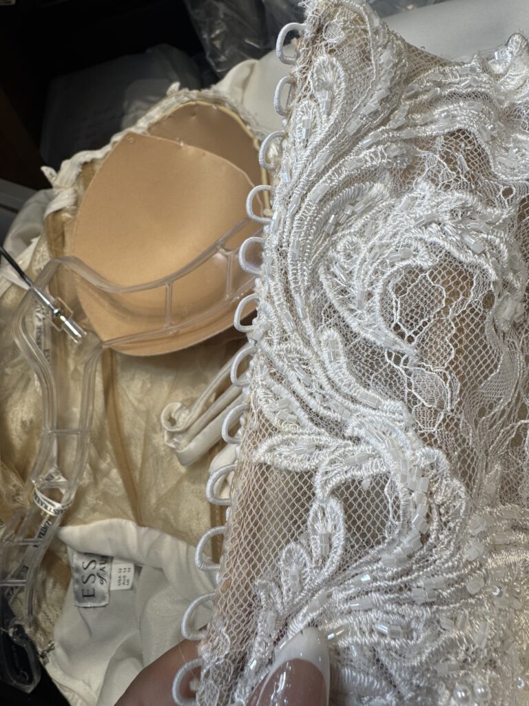 Beaded lace bodice of Essense of Australia wedding gown during bust contouring alterations