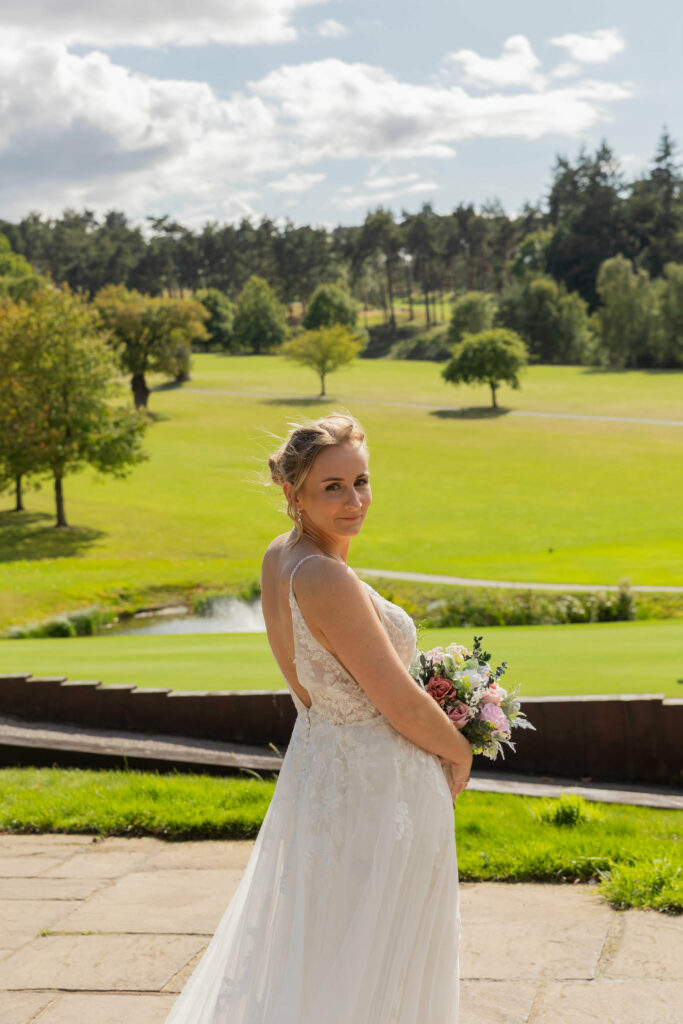 Bride wearing her altered Essense of Australia wedding dress following Kenley wedding dress alterations close up portrait.