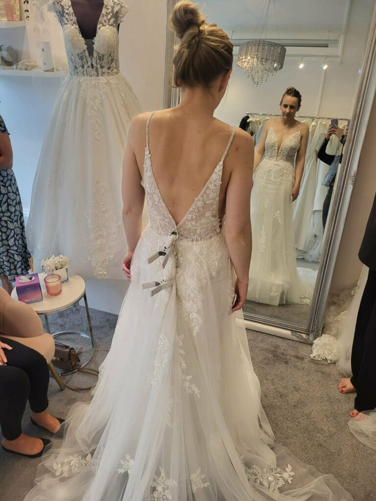 Before Kenley wedding dress alterations showing an Essense of Australia sample gown pinned for an eight-inch size reduction