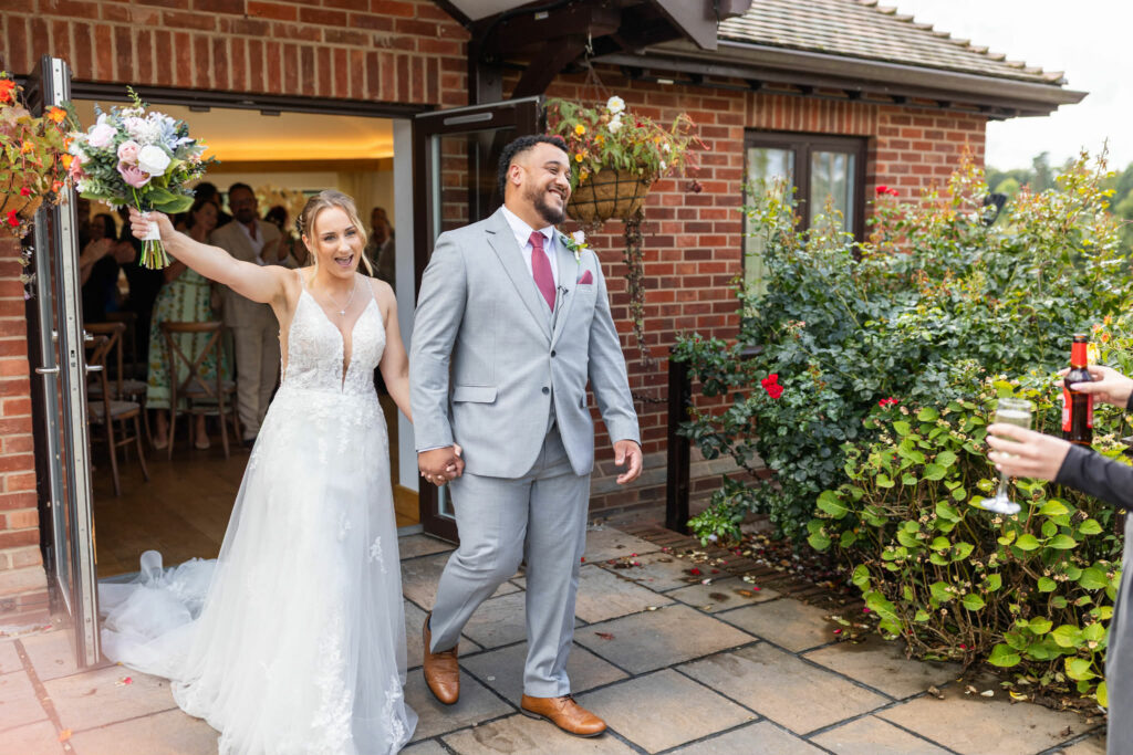 Bride wearing her altered Essense of Australia wedding dress following Kenley wedding dress alterations happily married.