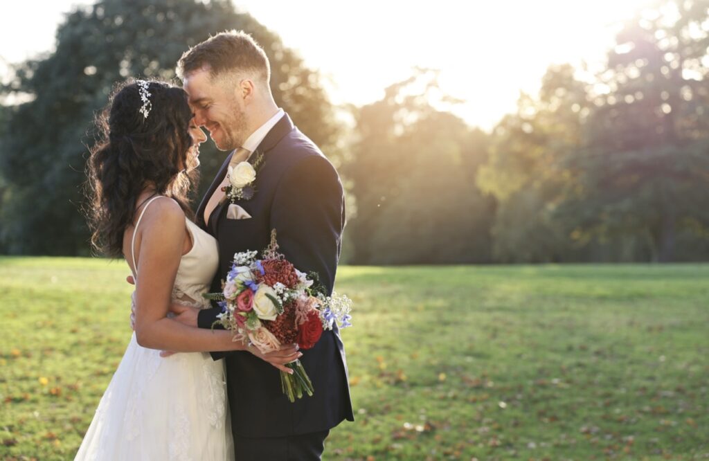 Golden hour wedding portrait highlighting the elegant fit of a couture altered wedding dress