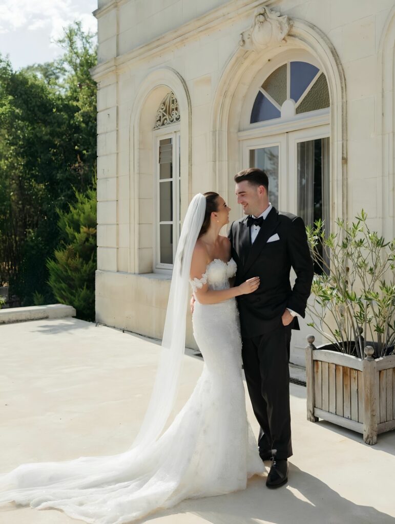 Outdoor wedding ceremony at Château Fengari with the bride wearing her altered Ricca Sposa Como gown