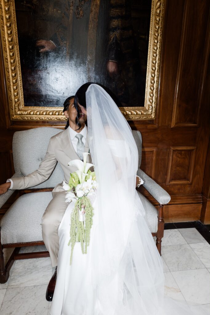 bride sitting on groom