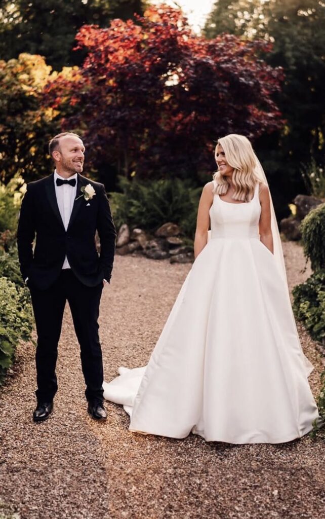 a Stella York designer dress with a couture bustle and bespoke bow.
