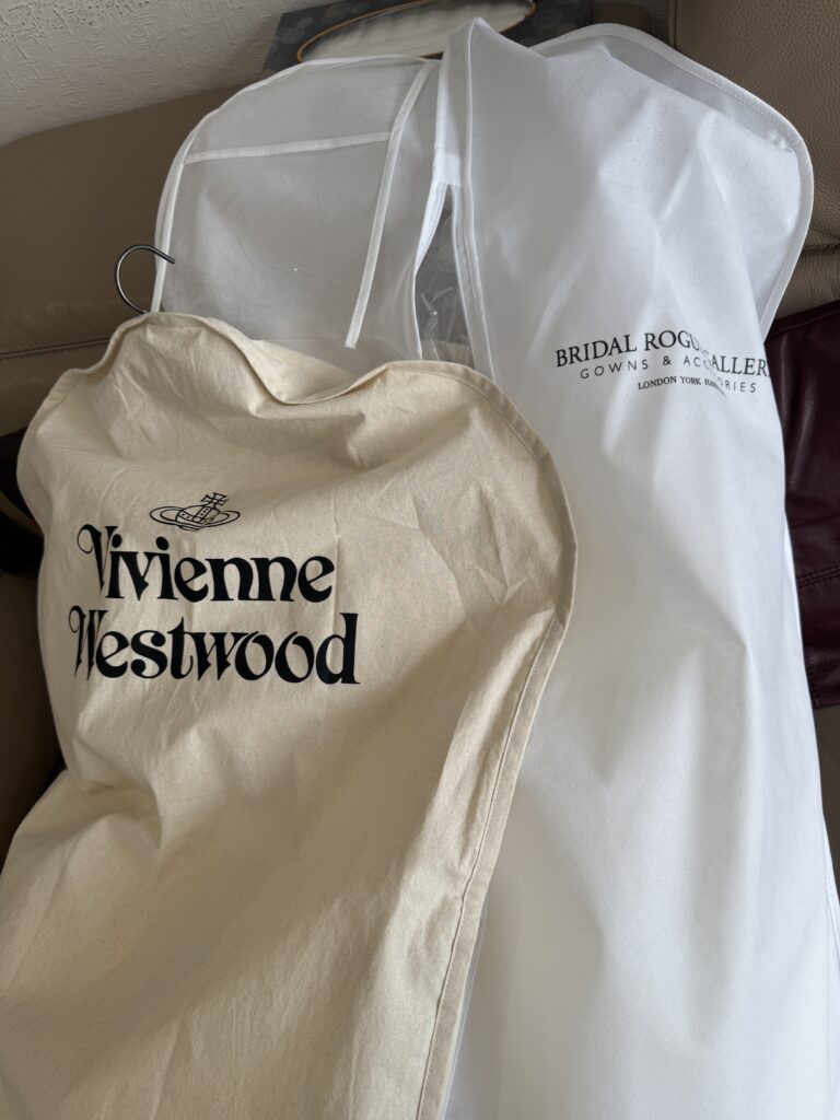Final fitting of a Vivienne Westwood Raven corset top with a Bridal Rouge Gallery skirt before the wedding in garment bag.